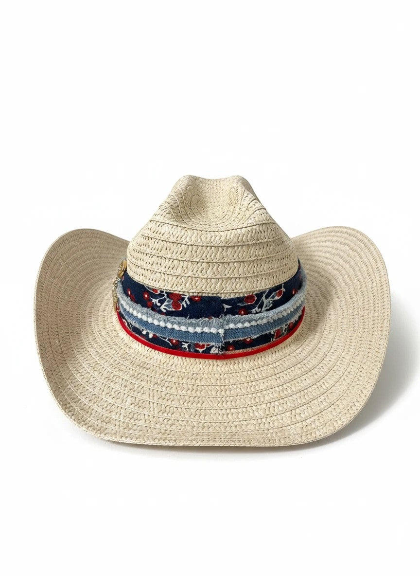 Adams + Hegwood woven straw western hat with a floral and denim layered band, red trim, and metallic star charm.