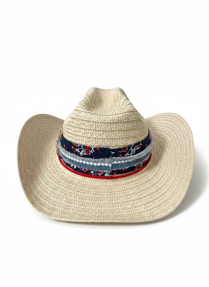 Adams + Hegwood woven straw western hat with a floral and denim layered band, red trim, and metallic star charm.
