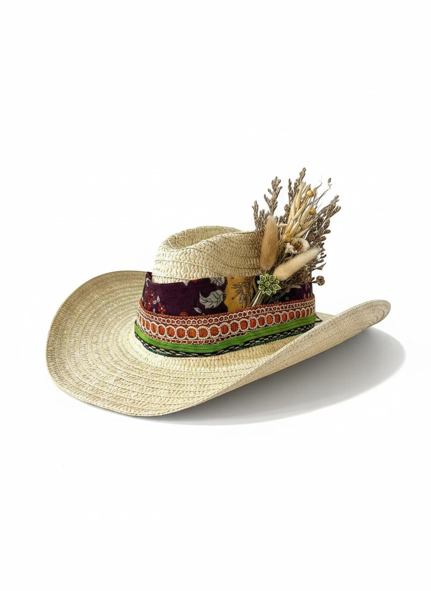 Adams + Hegwood straw cowboy hat with decorative band and dried flowers. Natural straw weave, boho style.