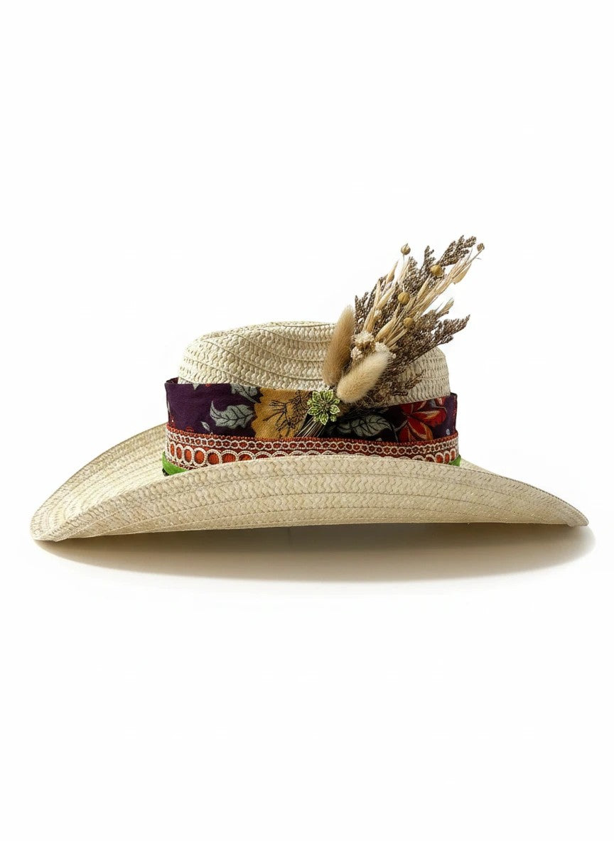 Adams + Hegwood natural straw cowboy hat with decorative band and dried flowers. Features a floral pattern and rustic embellishments.
