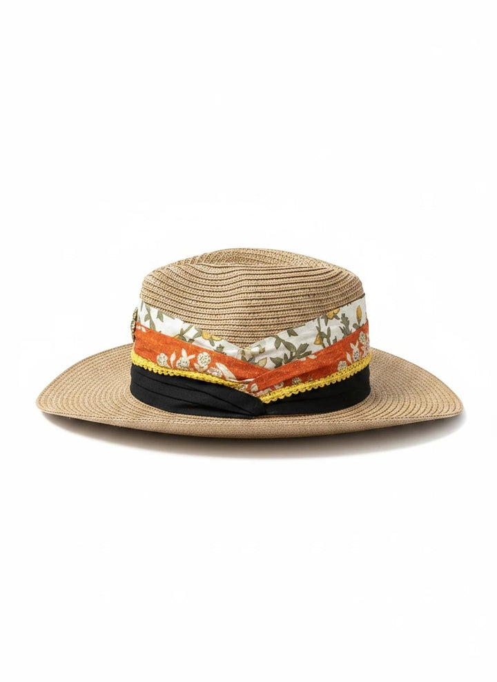 Adams + Hegwood straw fedora hat with a decorative multi-layered fabric band, floral print, and vintage brooch.