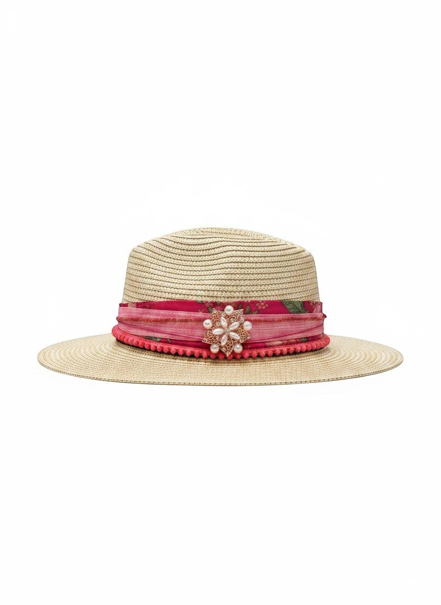 Adams + Hegwood straw fedora hat with pink floral band, pom-pom trim, and pearl brooch.