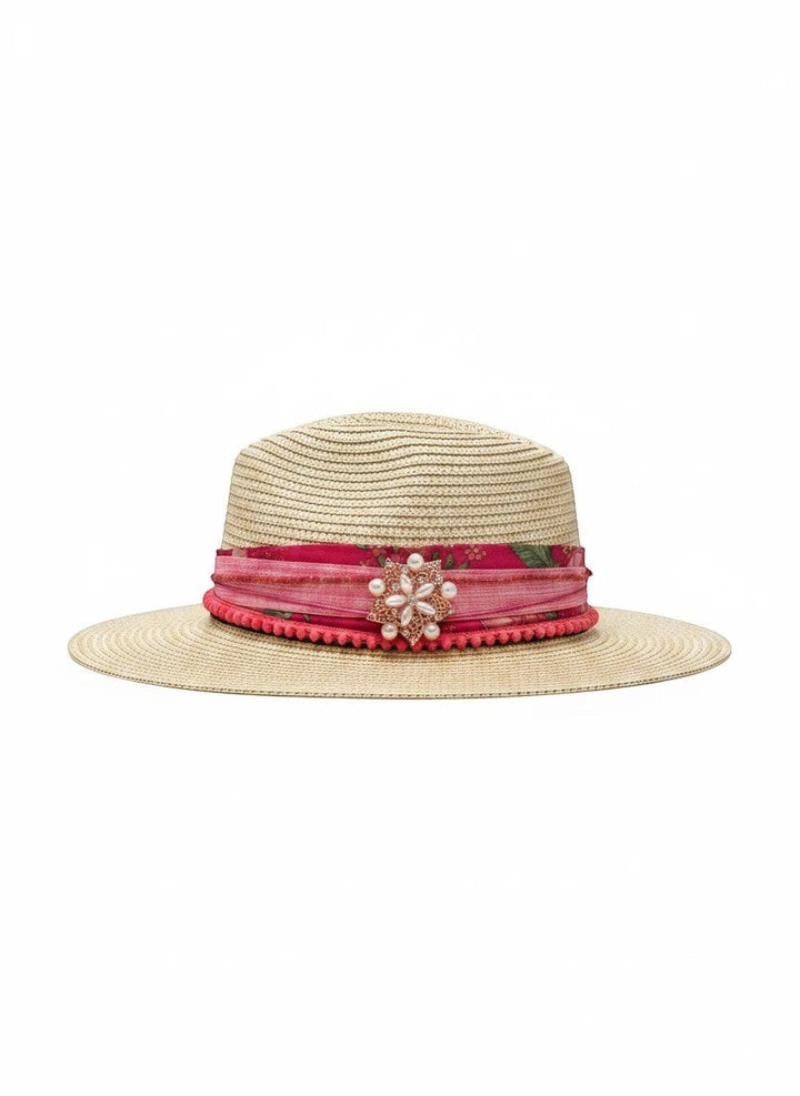 Adams + Hegwood straw fedora hat with pink floral band, pom-pom trim, and pearl brooch.