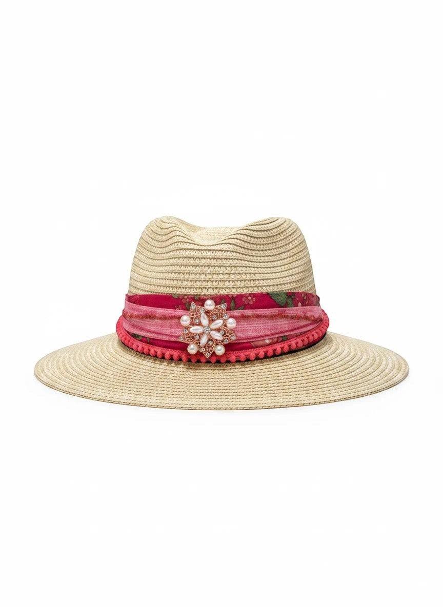Adams + Hegwood natural straw fedora hat with pink floral band, pom-pom trim, and pearl brooch.