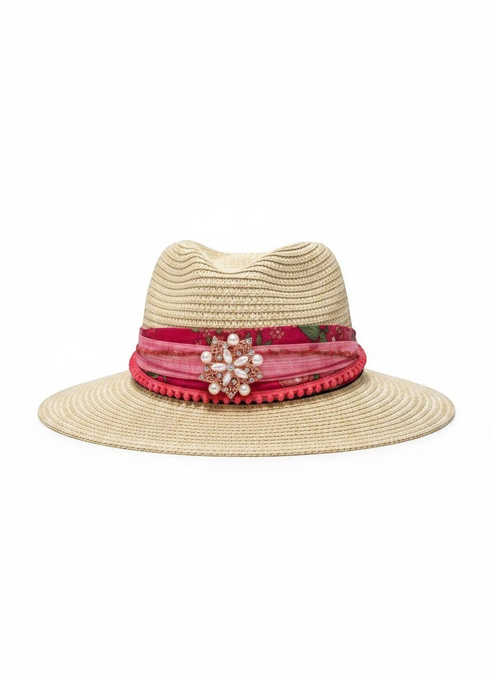 Adams + Hegwood natural straw fedora hat with pink floral band, pom-pom trim, and pearl brooch.