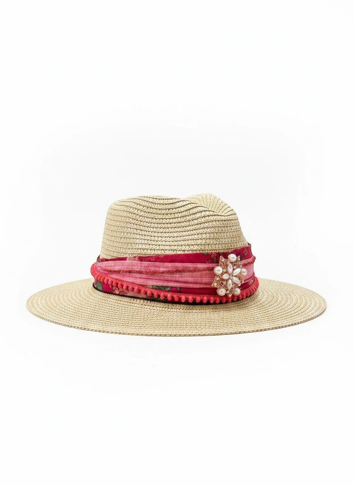 Adams + Hegwood straw fedora hat with pink floral band, pom-pom trim, and pearl brooch.