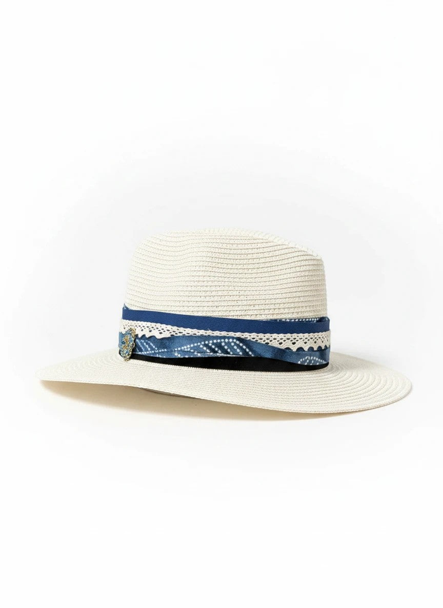 Adams + Hegwood woven straw fedora sun hat with a blue patterned fabric band, lace trim, and elegant embellishment.