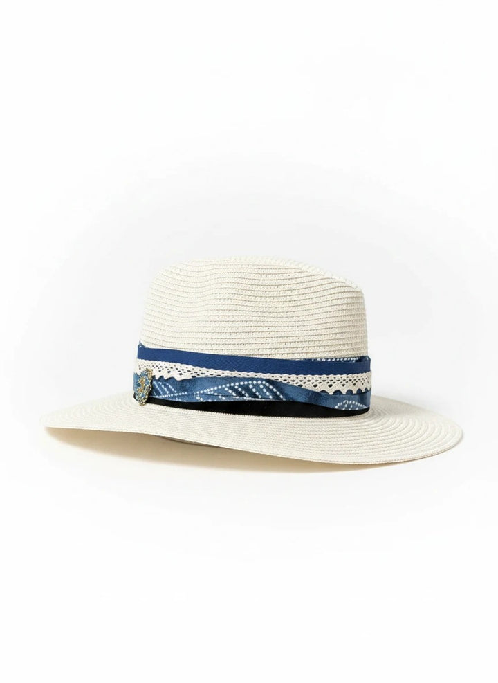Adams + Hegwood woven straw fedora sun hat with a blue patterned fabric band, lace trim, and elegant embellishment.