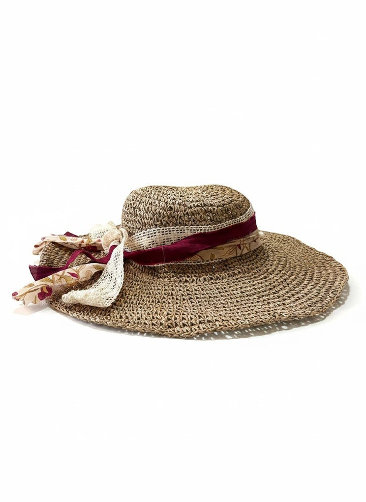 Adams + Hegwood woven wide brim sun hat with burgundy ribbon, lace trim, floral fabric, and faux pearls.