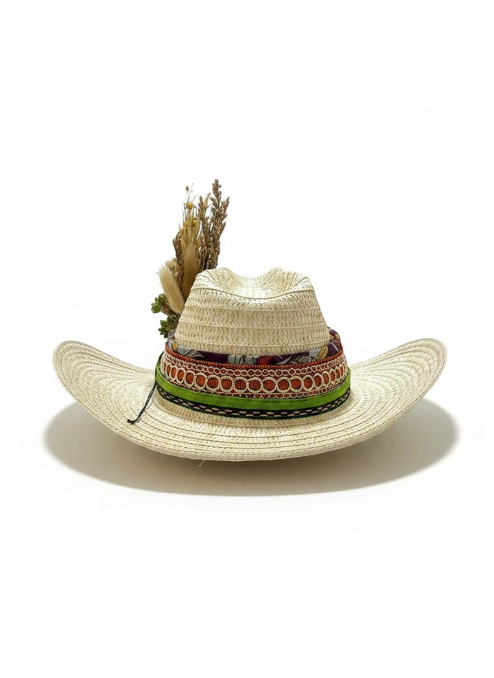 Adams + Hegwood straw cowboy hat with decorative band and dried flowers. Natural weave, earthy tones, bohemian style.