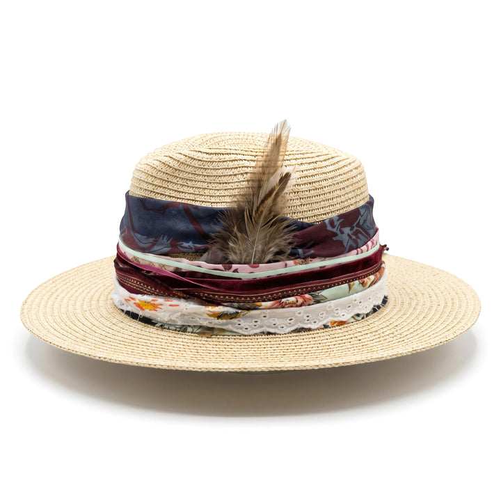 Natalie Adams Hegwood Studio wide brim straw hat with layered fabric ribbons, vintage trims, and a natural feather accent.