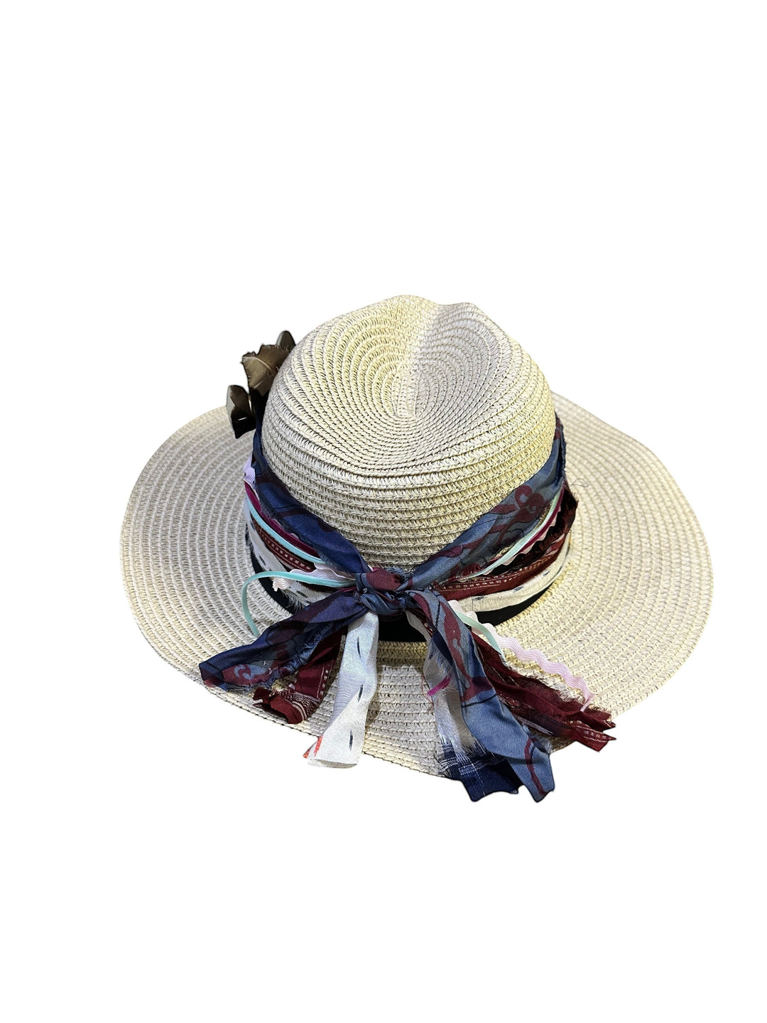 Natalie Adams Hegwood Studio bohemian straw hat with wide brim, layered fabric ribbons, and natural feather accents.