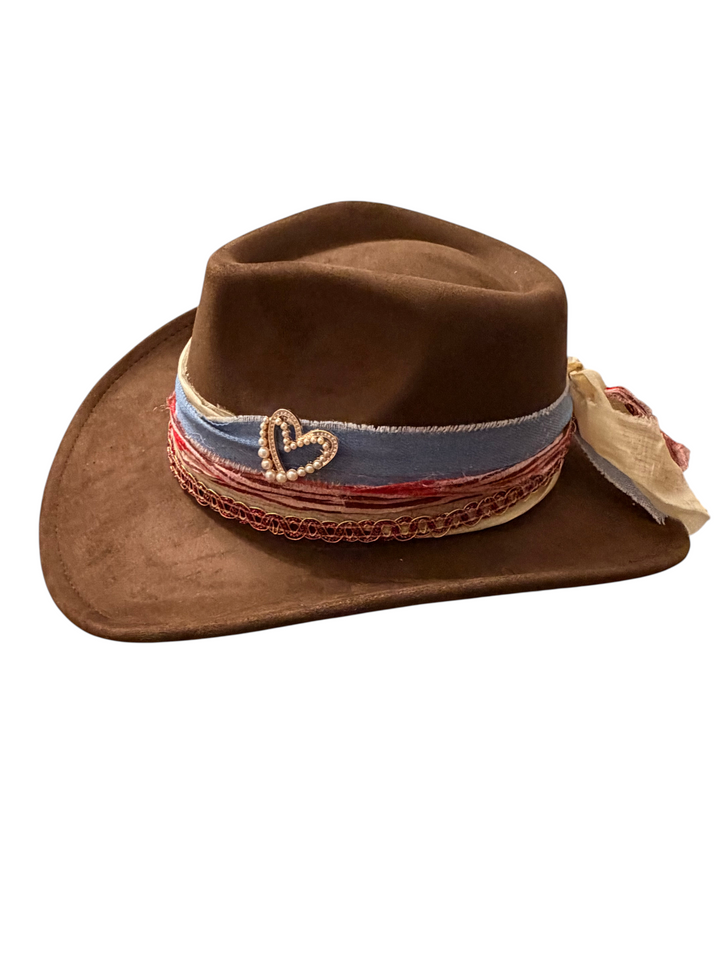 Natalie Adams Hegwood Studio brown suede cowgirl hat with a decorative layered fabric band and pearl heart charm