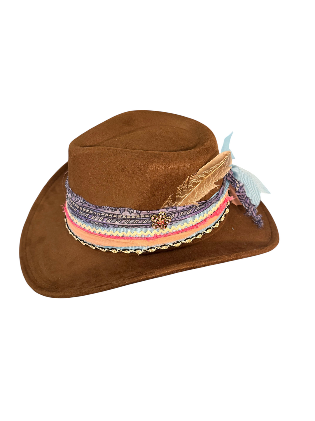 Natalie Adams Hegwood Studio handmade brown suede western hat with a pastel rainbow band, feather, and gold brooch.