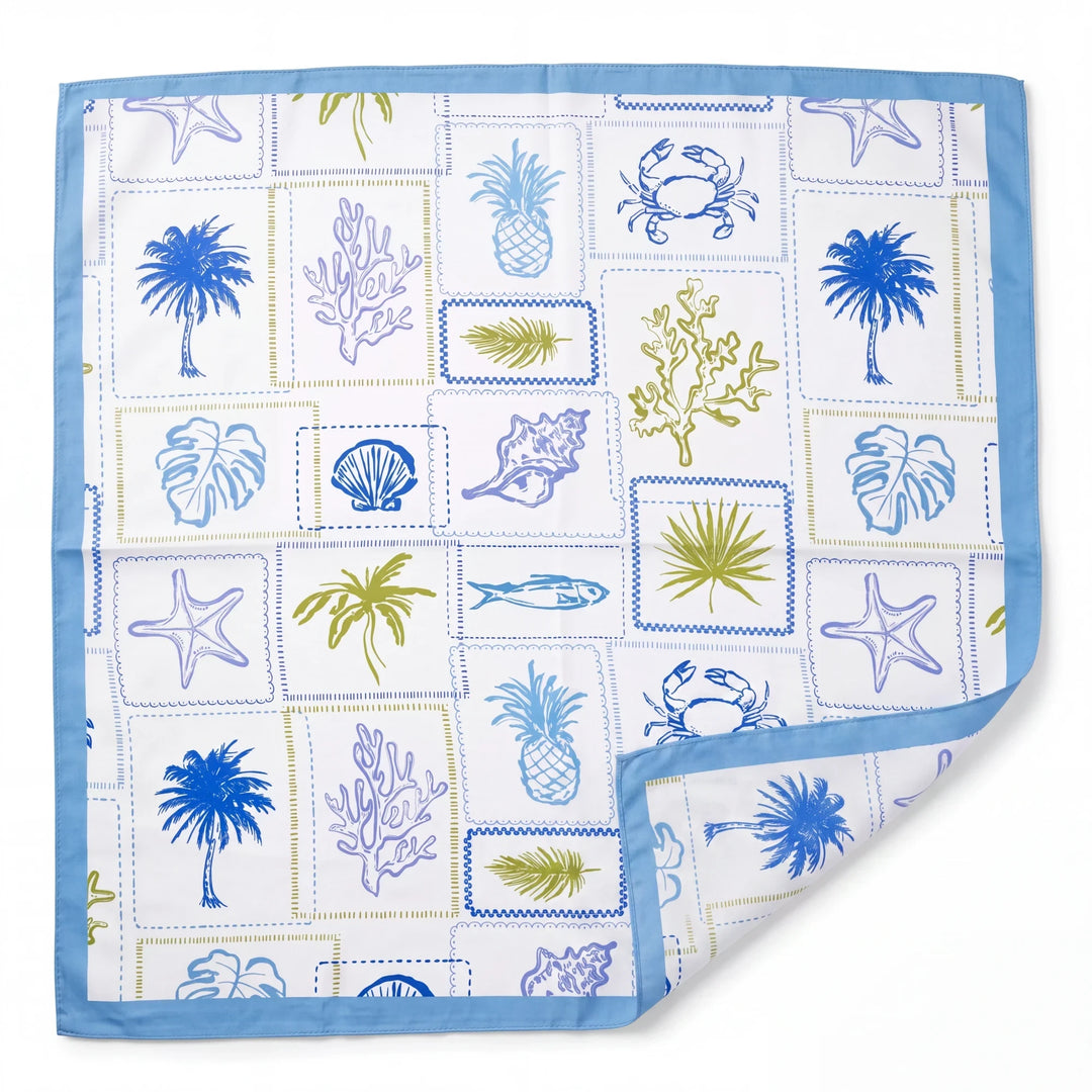 Natalie Adams Hegwood Studio square silk scarf with blue and green coastal motifs on a white background.