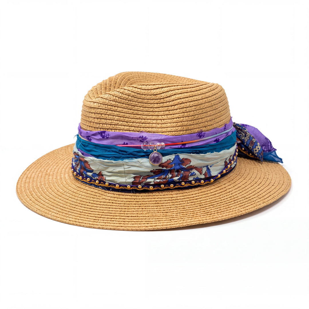 Natalie Adams Hegwood Studio straw fedora with layered purple and teal silk ribbons, gold beads, and a purple stone.
