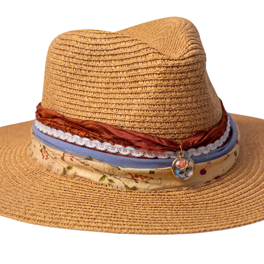 Natalie Adams Hegwood Studio tan straw fedora with layered rust gauze, lace, blue ribbon, floral cotton, and rose charm