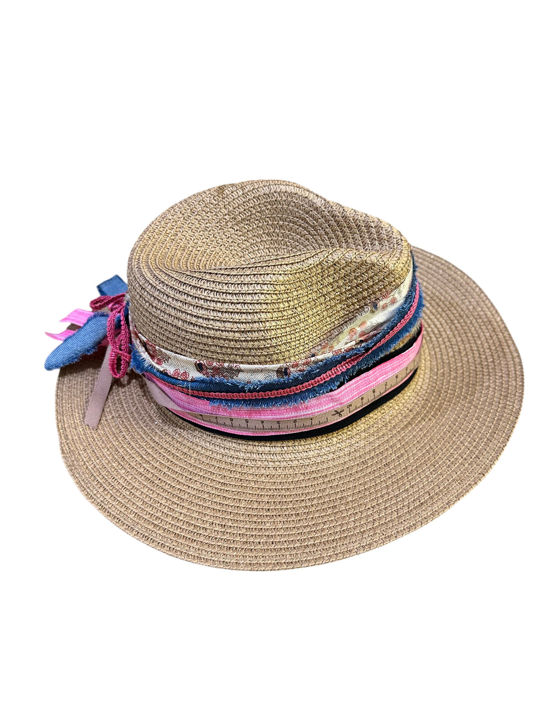 Natalie Adams Hegwood Studio straw fedora hat with a multi-layered fabric band and decorative floral accents.