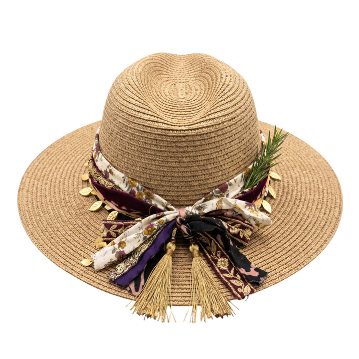 Natalie Adams Hegwood Studio wide brim straw fedora with a decorative floral fabric band, metallic leaves, and tassels.