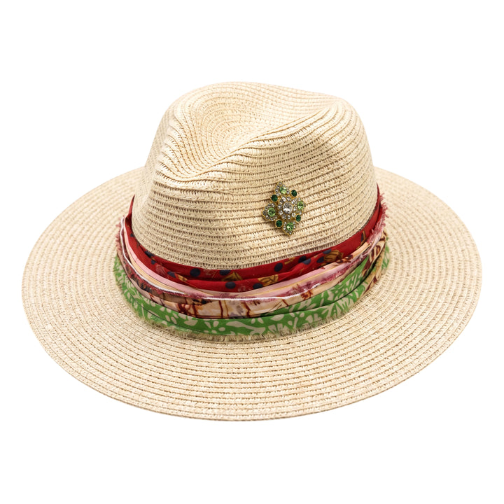 Natalie Adams Hegwood Studio straw fedora with a multi-layered fabric scarf band and a jewel-toned brooch accent.