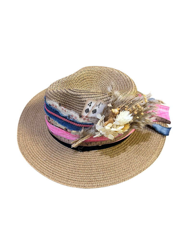 Natalie Adams Hegwood Studio straw fedora with multi-layered fabric trim, dried floral accents, and playing card detail.