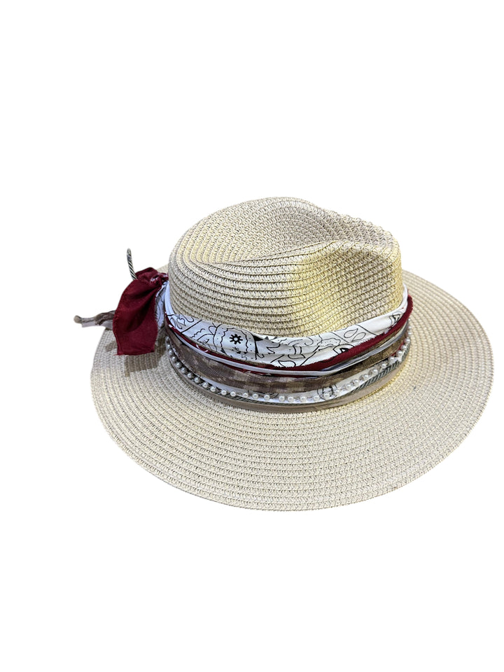 Natalie Adams Hegwood Studio straw fedora with a decorative band featuring fabric, pearls, and a feather accent.