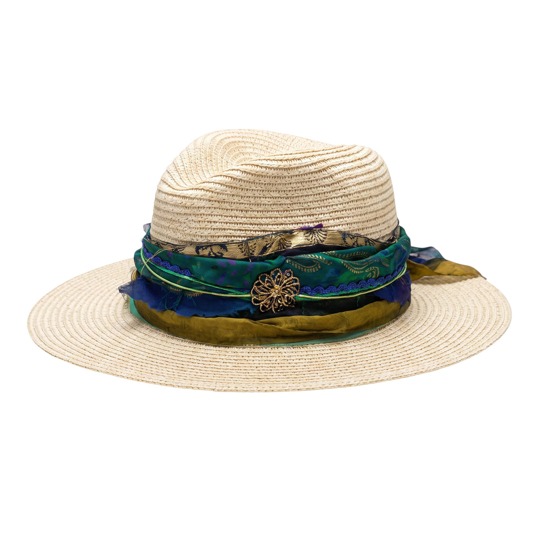 Natalie Adams Hegwood Studio wide brim straw fedora with a layered blue and green fabric band and floral brooch.