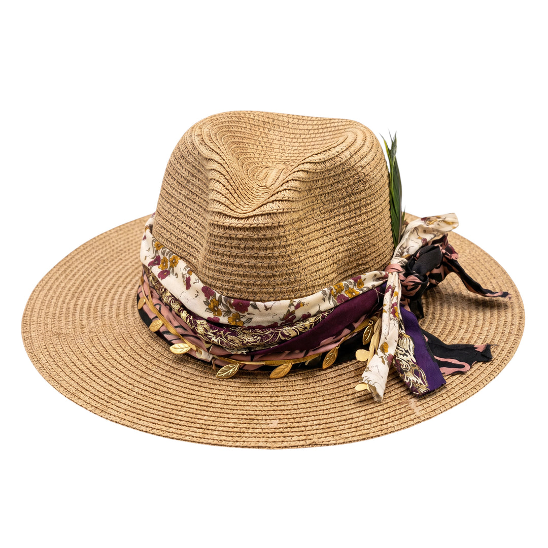Natalie Adams Hegwood Studio straw fedora with a wide brim, floral fabric band, metallic leaf accents, and feathers.