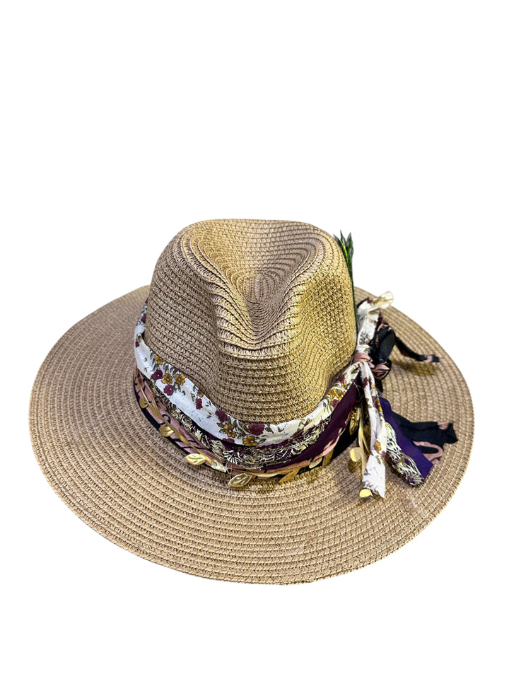 Natalie Adams Hegwood Studio wide brim straw fedora with a decorative floral ribbon, metallic leaves, and feather accents.