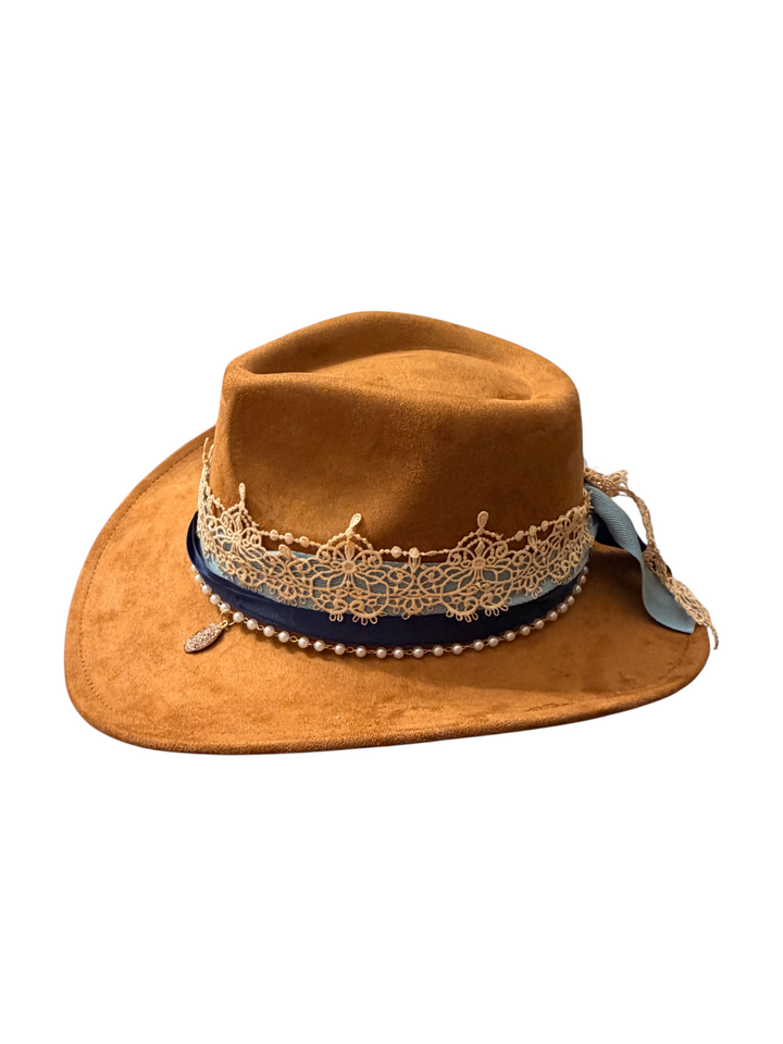 Natalie Adams Hegwood Studio tan suede cowgirl hat featuring a gold lace crown, navy ribbon, and ivory pearl trim.